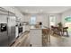 Spacious kitchen featuring stainless steel appliances, white cabinetry, and an island with bar stools at 3178 Birdsong Ave, Covington, GA 30016