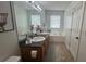 This bathroom features dual sinks, a soaking tub, and tiled floors, combining functionality and style at 51 Freedom Ne Dr, Cartersville, GA 30121