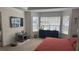 A bright bedroom features a trey ceiling, large windows, and is decorated with a modern bed set and abstract wall art at 51 Freedom Ne Dr, Cartersville, GA 30121