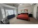 A bright bedroom features a trey ceiling, large windows, and is decorated with a modern bed set and abstract wall art at 51 Freedom Ne Dr, Cartersville, GA 30121