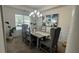 Traditional dining room with wainscoting, modern chandelier, large window, and elegant wooden table with upholstered chairs at 51 Freedom Ne Dr, Cartersville, GA 30121