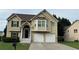 Traditional two-story home features a two-car garage, brick-accented entrance, manicured lawn and decorative trim work at 51 Freedom Ne Dr, Cartersville, GA 30121