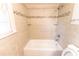 Tiled bathroom with tub and shower at 1443 Snapfinger Rd, Decatur, GA 30032
