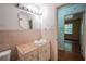 Bathroom with toilet, vanity with granite countertop and sink, and decorative tile backsplash at 1443 Snapfinger Rd, Decatur, GA 30032