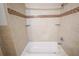 Tiled bathtub and shower with decorative tile accent offers a clean and modern feel at 1443 Snapfinger Rd, Decatur, GA 30032
