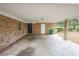 Carport made of brick with a concrete slab and covering to provide covered parking at 1443 Snapfinger Rd, Decatur, GA 30032