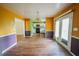Dining room with wood floors and natural light flowing from the kitchen at 1443 Snapfinger Rd, Decatur, GA 30032
