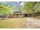 Charming single-story brick home with a covered front porch and a stone walkway at 1443 Snapfinger Rd, Decatur, GA 30032