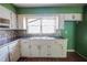 Kitchen showcasing white cabinets, stainless steel sink and window at 1443 Snapfinger Rd, Decatur, GA 30032