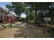 The house's backyard with a paver patio, dining set, upper deck, and lush greenery at 1915 Milfield Cir, Snellville, GA 30078