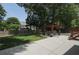 A home's backyard with a paver patio, dining set, and lush greenery at 1915 Milfield Cir, Snellville, GA 30078