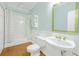 Bathroom featuring hardwood floors, a decorative mirror, and a shower/tub combo at 1915 Milfield Cir, Snellville, GA 30078