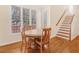 Dining area with hardwood floors, staircase, and large windows at 1915 Milfield Cir, Snellville, GA 30078