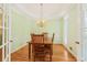 Elegant dining room featuring classic hardwood floors, a chandelier, and a square table at 1915 Milfield Cir, Snellville, GA 30078