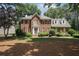 Charming two-story brick home with a well-manicured lawn and mature trees at 1915 Milfield Cir, Snellville, GA 30078