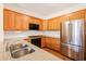 Bright kitchen with wooden cabinets, granite countertops, and stainless steel appliances at 1915 Milfield Cir, Snellville, GA 30078