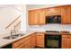 Well-lit kitchen with wood cabinets, tile backsplash, and modern appliances at 1915 Milfield Cir, Snellville, GA 30078