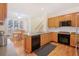 Open kitchen with wooden cabinets, granite countertops, and stainless steel appliances at 1915 Milfield Cir, Snellville, GA 30078