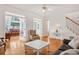 Open-concept living area with hardwood floors and many windows at 1915 Milfield Cir, Snellville, GA 30078