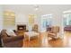 Spacious living room featuring a fireplace, hardwood floors, and built-in shelving at 1915 Milfield Cir, Snellville, GA 30078