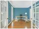 Bright office with hardwood floors, blue accent walls, and a view of the front yard at 1915 Milfield Cir, Snellville, GA 30078