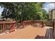 A medium eye-level shot of the rear deck featuring wood floors and access to the yard at 1915 Milfield Cir, Snellville, GA 30078
