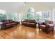 Bright sunroom with hardwood floors, many windows, and comfortable seating at 1915 Milfield Cir, Snellville, GA 30078
