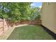 View of fenced-in backyard with lawn and mulched area at 2350 Twelvestones Dr, Roswell, GA 30076