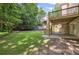 Spacious backyard featuring a well-maintained lawn, deck with stairs, and wooded views at 2350 Twelvestones Dr, Roswell, GA 30076