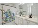 Bright bathroom featuring double sink vanity, quartz countertop, and a stylish shower curtain at 2350 Twelvestones Dr, Roswell, GA 30076