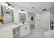 This bathroom features a dual vanity with a soaking tub and frameless shower at 2350 Twelvestones Dr, Roswell, GA 30076