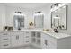 Bathroom featuring dual sinks with white cabinets, modern fixtures, and marble countertops at 2350 Twelvestones Dr, Roswell, GA 30076