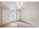Well-lit bedroom with a window seat, a ceiling fan, and neutral carpeting at 2350 Twelvestones Dr, Roswell, GA 30076