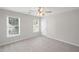 Bright, airy bedroom with neutral carpet and two large windows at 2350 Twelvestones Dr, Roswell, GA 30076