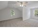 Attic bedroom with high angled ceilings, neutral carpet, and large windows at 2350 Twelvestones Dr, Roswell, GA 30076