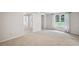 Bright bedroom with neutral walls and carpeting and large window with backyard views at 2350 Twelvestones Dr, Roswell, GA 30076