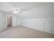 Attic bedroom with high angled ceilings, neutral carpet, and many doors at 2350 Twelvestones Dr, Roswell, GA 30076