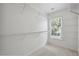 Walk-in closet with built-in shelves and large window at 2350 Twelvestones Dr, Roswell, GA 30076