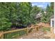 Wooden deck overlooking a private backyard with mature trees and professional landscaping at 2350 Twelvestones Dr, Roswell, GA 30076