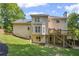 Exterior of home with deck and patio overlooking grassy yard at 2350 Twelvestones Dr, Roswell, GA 30076