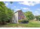 Exterior of home with lush landscaping and partial brick facade at 2350 Twelvestones Dr, Roswell, GA 30076