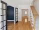 Open foyer with wood floors and an open view to the other rooms of the house at 2350 Twelvestones Dr, Roswell, GA 30076