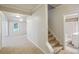 Hallway leading to carpeted living area and a bathroom with carpeted stairs at 2350 Twelvestones Dr, Roswell, GA 30076