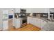 Well-lit kitchen with granite counters, stainless steel appliances, and stylish tile backsplash at 2350 Twelvestones Dr, Roswell, GA 30076