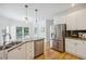 Kitchen with white cabinets, stainless steel appliances, granite countertops and hardwood floors at 2350 Twelvestones Dr, Roswell, GA 30076