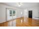 An empty living room featuring hardwood floors, neutral walls, and large windows overlooking the yard at 2350 Twelvestones Dr, Roswell, GA 30076
