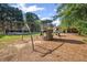 Community playground featuring swings and a play structure near the pool area, providing entertainment for families at 2350 Twelvestones Dr, Roswell, GA 30076