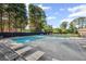 Community pool with lounge chairs and shaded seating at 2350 Twelvestones Dr, Roswell, GA 30076