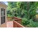 A cozy wooden back deck overlooks the lush green foliage, providing a private outdoor retreat at 26 Springbottom Dr, Lawrenceville, GA 30046