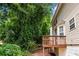 View of the wooden back porch surrounded by trees and greenery at 26 Springbottom Dr, Lawrenceville, GA 30046